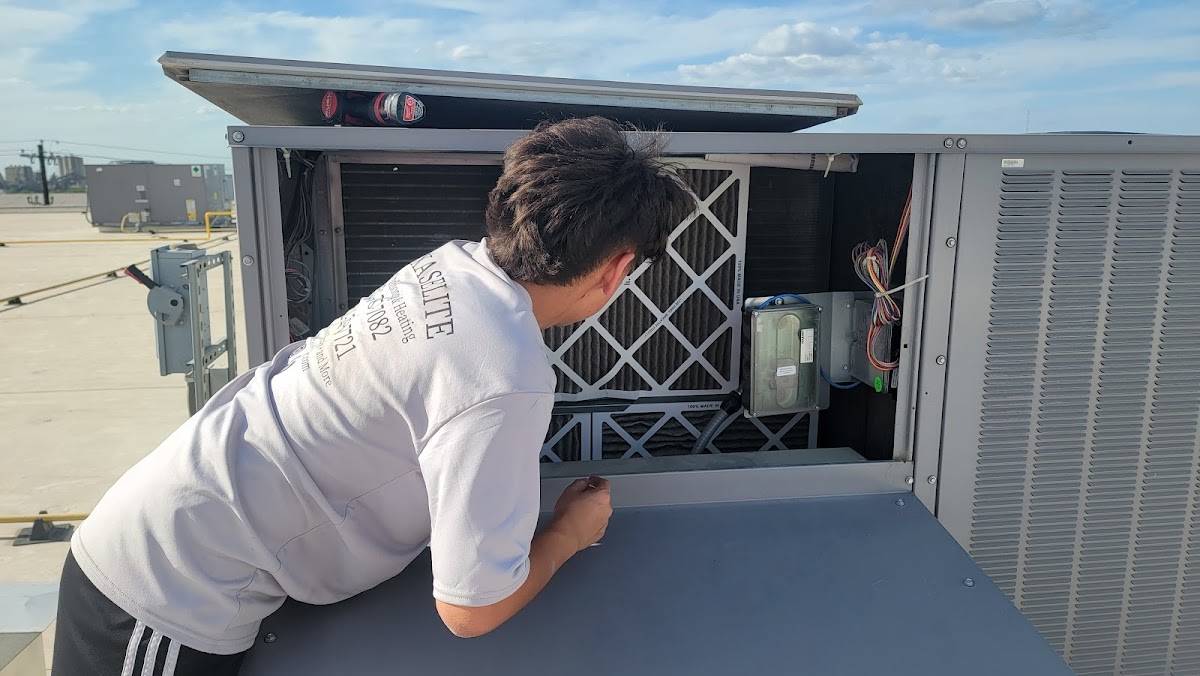 Texas Elite HVAC technician servicing rooftop AC unit